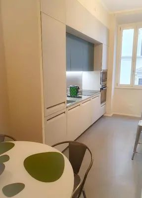 a kitchen with a table and chairs in a room at Youcomehere - Montebello in Rome