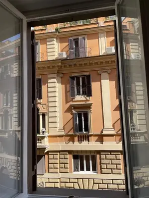 a view of a building through a window at Dolcevita’s House in Rome