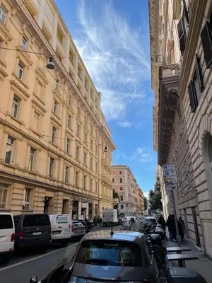 a city street with parked cars and buildings at Dolcevita’s House in Rome