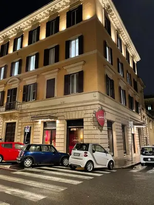 two cars parked in front of a building at Dolcevita’s House in Rome