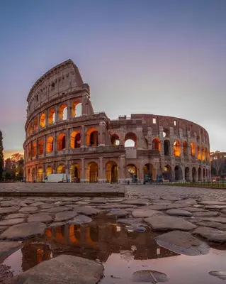 a large building with a puddle in front of it at Dolcevita’s House in Rome
