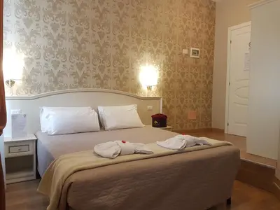 a bedroom with a bed with two towels on it at Relais Bocca di Leone in Rome