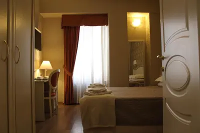 a hotel room with a bed and a window at Relais Bocca di Leone in Rome