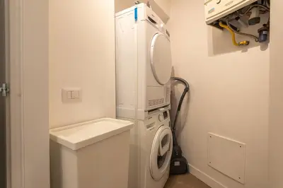 a white laundry room with a washer and dryer at Trastevere at heart in Rome