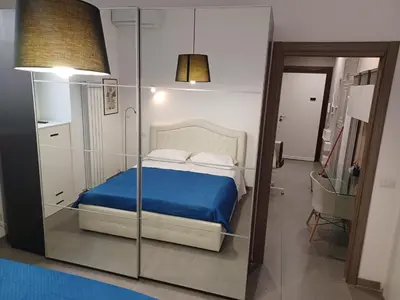 a bedroom with a bed with a blue blanket at casa Nannarè in Rome