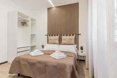 a bedroom with a bed with two towels on it at Casa Roma B&B in Rome