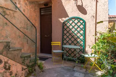 two chairs and a table in front of a door at Studio in Trastevere Village in Rome