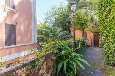 a street light next to a building with plants at Studio in Trastevere Village in Rome