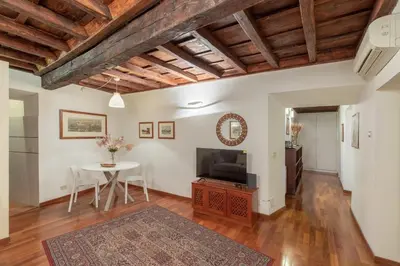 a living room with a table and a tv at iFlat Comfy Apartament in Campo de' Fiori in Rome