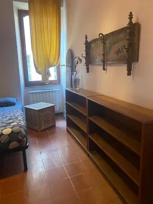 a room with a wooden dresser and a window at CASA PANIERI in Rome
