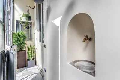 an alleyway with a sink in a white wall at Heritage Miracle Suite in Rome