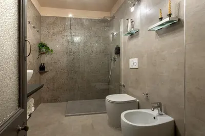 a bathroom with a toilet and a sink and a shower at Heritage Miracle Suite in Rome