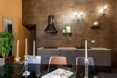 a kitchen with a dining table and a stove at Heritage Miracle Suite in Rome