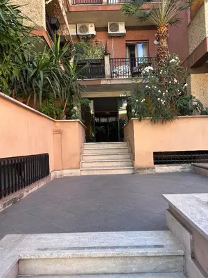a building with stairs and plants in a courtyard at Magenta Terrione 2 in Rome