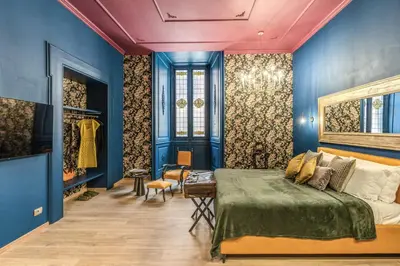 a bedroom with blue walls and a bed at Corso Miracle Suite in Rome