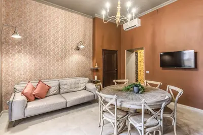 a living room with a couch and a table at Corso Miracle Suite in Rome