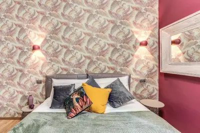a bedroom with a bed with three pillows on it at Corso Miracle Suite in Rome