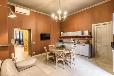 a kitchen and dining room with a table and a couch at Corso Miracle Suite in Rome