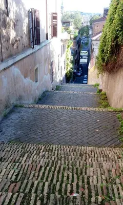 an alley way with a cobblestone street next to a building at Le Scale di Roma in Rome
