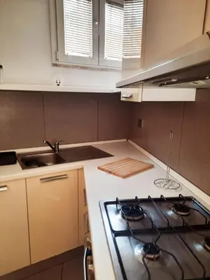 a kitchen with a stove and a counter top at Le Scale di Roma in Rome