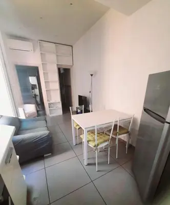 a living room with a white table and a couch at Le Scale di Roma in Rome