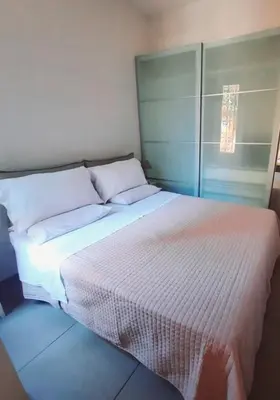a bedroom with a large bed with white sheets at Le Scale di Roma in Rome