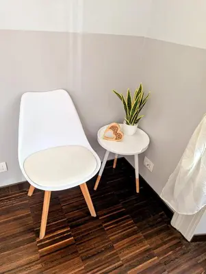 a white chair and a table with a plant on it at DM69 - Termini Monti Crossroads in Rome