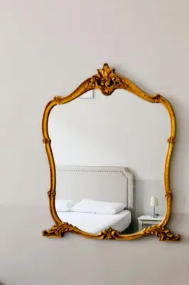 a mirror hanging on a wall in a room at DM69 - Termini Monti Crossroads in Rome