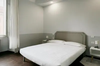a bedroom with a white bed with a white bedspread at DM69 - Termini Monti Crossroads in Rome