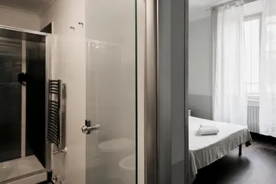 a bathroom with a shower and a toilet and a sink at DM69 - Termini Monti Crossroads in Rome