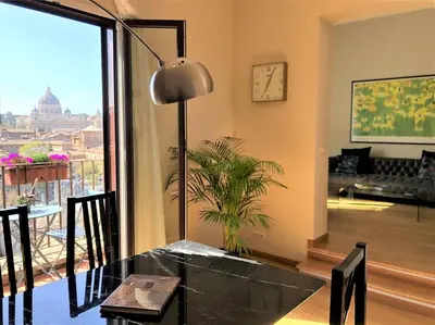 a dining room with a table and a large window at La Torre di Castel Sant'Angelo in Rome