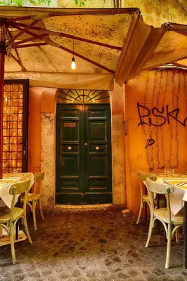 a green door in a building with tables and chairs at Accogliente intero appartamento in Rome