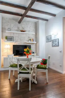 a white dining room with a white table and chairs at Accogliente intero appartamento in Rome