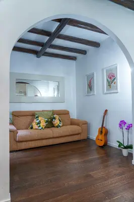 a living room with a couch and a guitar at Accogliente intero appartamento in Rome