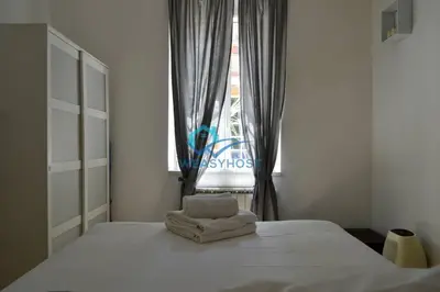 a bedroom with a bed with two towels on it at Pigneto Modern Apartment in Rome