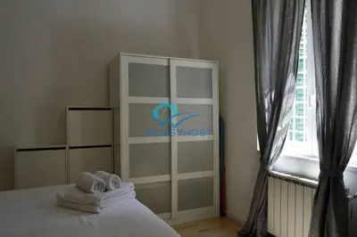a bedroom with a bed with towels and a window at Pigneto Modern Apartment in Rome
