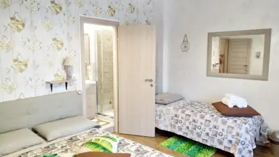 a small bedroom with a bed and a mirror at San Pietro Shabby Chic Apartment in Rome