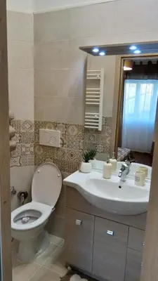 a bathroom with a toilet and a sink at San Pietro Shabby Chic Apartment in Rome