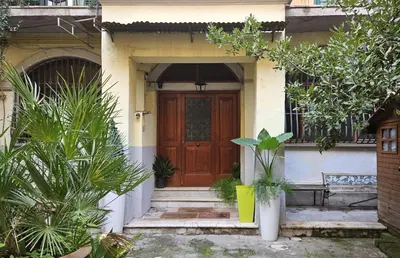 a house with a wooden door and some plants at ACasaMiaSanPietro in Rome