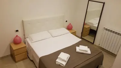 a bedroom with a large bed with a mirror at ACasaMiaSanPietro in Rome