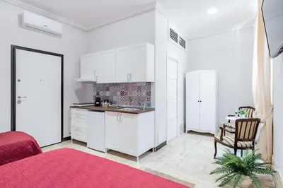 a bedroom with a red bed with two white towels at BARONE HOUSE in Rome