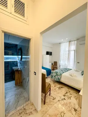 a bedroom with a bed and a bathroom with a shower at BARONE HOUSE in Rome