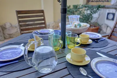 a wooden table with a glass pitcher of water on it at Colosseo Residenza Sette Sale in Rome