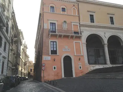 a building on a cobblestone street in a city at Colosseo Residenza Sette Sale in Rome