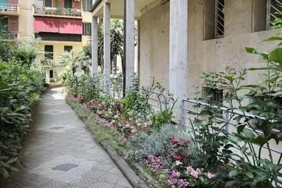a garden with flowers next to a building at Suite RHome In Vatican in Rome