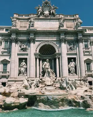 a building with a fountain in front of it at Suite RHome In Vatican in Rome