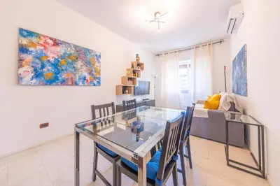 a dining room with a glass table and chairs at Lungotevere Apartment in Rome