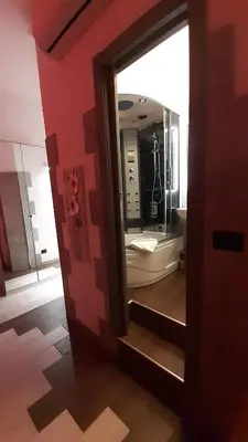a mirror in a bathroom with a sink and a tub at HARMONY RELAX HYDROMASSAGE SAUNA AT THE VATICAN MUSEUMS in Rome