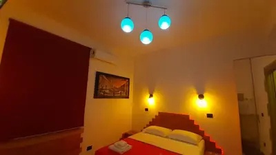 a bedroom with a bed and lights on the wall at HARMONY RELAX HYDROMASSAGE SAUNA AT THE VATICAN MUSEUMS in Rome
