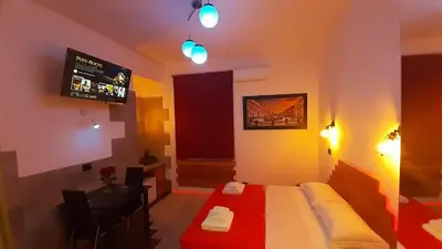 a bedroom with a bed and a table and lights at HARMONY RELAX HYDROMASSAGE SAUNA AT THE VATICAN MUSEUMS in Rome